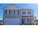 Two story home with a white garage door, neutral siding, black shutters and a porch at 528 Scarlet Sage Dr., Conway, SC 29527