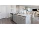 Kitchen island with granite countertops, stainless appliances, and gray cabinets at 528 Scarlet Sage Dr., Conway, SC 29527