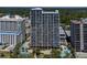 A high-rise condo building featuring pools, palm trees, and other beachside amenities at 5308 N Ocean Blvd. # 504, Myrtle Beach, SC 29577