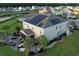 Aerial view featuring a spacious home equipped with solar panels, screened in porch, and an outdoor seating area at 5809 Oakbury Ct., Myrtle Beach, SC 29579