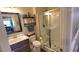 Well-lit bathroom featuring a glass-enclosed shower, vanity with mirror, and tiled flooring at 5809 Oakbury Ct., Myrtle Beach, SC 29579