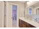 Bathroom vanity with wood cabinets, and view into pink-themed room at 5809 Oakbury Ct., Myrtle Beach, SC 29579