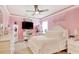 Cheerful bedroom with pink striped walls, white furniture and decor at 5809 Oakbury Ct., Myrtle Beach, SC 29579