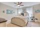Comfortable bedroom with a ceiling fan, a decorative headboard, and soft, neutral tones at 5809 Oakbury Ct., Myrtle Beach, SC 29579