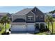 Two-story home with a two-car garage, neutral siding and well-manicured lawn and landscaping at 5809 Oakbury Ct., Myrtle Beach, SC 29579