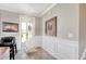 Elegant foyer featuring wainscoting, wood floors, and a stylish front door with glass inserts at 5809 Oakbury Ct., Myrtle Beach, SC 29579