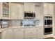 Modern kitchen features white cabinetry, stainless steel appliances, gas range, and decorative backsplash at 5809 Oakbury Ct., Myrtle Beach, SC 29579