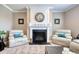 Living room featuring a fireplace with a decorative mantel, comfortable seating, and neutral decor at 5809 Oakbury Ct., Myrtle Beach, SC 29579