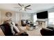 Relaxing living room with a large TV, comfortable seating, and a stylish ceiling fan at 5809 Oakbury Ct., Myrtle Beach, SC 29579