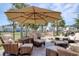 Outdoor lounge area with umbrellas, wicker chairs, and decorative water feature at 5809 Oakbury Ct., Myrtle Beach, SC 29579