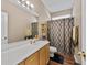 Bathroom featuring a single sink vanity, toilet, and shower with an elegant curtain rod at 5916 Falcon Landing Circle, North Myrtle Beach, SC 29582