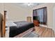 Cozy bedroom features wood floors, ceiling fan, dresser, and television for comfortable living at 5916 Falcon Landing Circle, North Myrtle Beach, SC 29582