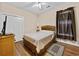 Cozy bedroom with wood floors, closet, ceiling fan, and window with privacy blinds at 5916 Falcon Landing Circle, North Myrtle Beach, SC 29582