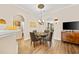 Cozy dining area featuring a modern chandelier and sleek, dark wood-like flooring at 5916 Falcon Landing Circle, North Myrtle Beach, SC 29582