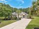 Stately single-Gathering home featuring mature landscaping and a long driveway surrounded by grass at 5916 Falcon Landing Circle, North Myrtle Beach, SC 29582