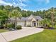 Charming single-Gathering home showcasing mature landscaping and a long driveway and attached garage at 5916 Falcon Landing Circle, North Myrtle Beach, SC 29582