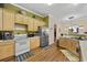 Functional kitchen with wood cabinets, stainless steel refrigerator, and tile flooring at 5916 Falcon Landing Circle, North Myrtle Beach, SC 29582