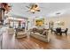 Open-concept living room boasts wood floors and an inviting layout with a ceiling fan at 5916 Falcon Landing Circle, North Myrtle Beach, SC 29582