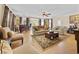 Expansive living room with bar area, large windows, and comfortable seating arrangement at 5916 Falcon Landing Circle, North Myrtle Beach, SC 29582
