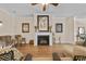 Inviting living room featuring a fireplace with mantle, neutral colored walls and hardwood floors at 5916 Falcon Landing Circle, North Myrtle Beach, SC 29582