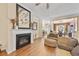 Bright living room featuring a fireplace, ample natural light, and wood-look flooring at 5916 Falcon Landing Circle, North Myrtle Beach, SC 29582