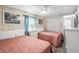 Bright bedroom features two twin beds, coastal décor, and whitewashed walls at 6001- 5718 S Kings Highway, Myrtle Beach, SC 29575