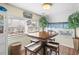 Cozy dining area with a wood table, stools, and bright natural light at 6001- 5718 S Kings Highway, Myrtle Beach, SC 29575