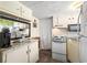 A functional kitchen features white appliances, a microwave, and countertops with available storage at 6001- 5718 S Kings Highway, Myrtle Beach, SC 29575