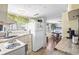 The kitchen features neutral counters, a sink, and white appliances with sight lines to the dining area at 6001- 5718 S Kings Highway, Myrtle Beach, SC 29575