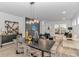 Contemporary dining area with unique lighting fixture, modern decor, and connecting living space at 6076 Campanella St., Myrtle Beach, SC 29577