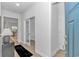 Bright entryway featuring a hallway, white walls, wood floors, and doors to other rooms of the home at 6076 Campanella St., Myrtle Beach, SC 29577