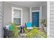 Cozy front porch featuring outdoor seating and a vibrant blue front door at 6076 Campanella St., Myrtle Beach, SC 29577