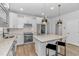 Bright kitchen featuring white cabinets, stainless steel appliances, and a granite island at 6076 Campanella St., Myrtle Beach, SC 29577