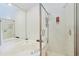 Bathroom featuring separate tub and shower with tiled walls, mirrors, and glass doors at 613 13Th Ave. S # 147, Surfside Beach, SC 29575