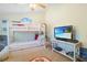 Charming bedroom features a bunk bed, ceiling fan, and entertainment center at 613 13Th Ave. S # 147, Surfside Beach, SC 29575