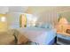 A pretty bedroom with soft pastels boasts a wall mirror and an ensuite bathroom at 613 13Th Ave. S # 147, Surfside Beach, SC 29575