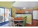 Eat-in kitchen with wood table, balcony access, and modern cabinets at 613 13Th Ave. S # 147, Surfside Beach, SC 29575