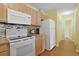 Functional kitchen with white appliances, granite counters, and light wood cabinetry at 613 13Th Ave. S # 147, Surfside Beach, SC 29575