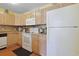 Efficient kitchen featuring white appliances and light wood cabinets at 613 13Th Ave. S # 147, Surfside Beach, SC 29575