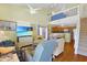 Cozy living room with high ceilings, ceiling fans, stairs, and open access to the kitchen at 613 13Th Ave. S # 147, Surfside Beach, SC 29575