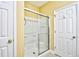Bathroom featuring glass enclosed shower with tile surround and white door at 6172 Catalina Dr. # 214, North Myrtle Beach, SC 29582