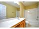 Bathroom showcases a vanity with a large mirror and a shower-tub combo with white tiling at 6172 Catalina Dr. # 214, North Myrtle Beach, SC 29582