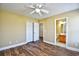 Bedroom with wood-look floors, a closet, and an en-suite bathroom with dual closets and a vanity at 6172 Catalina Dr. # 214, North Myrtle Beach, SC 29582