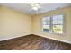 Sunlit bedroom with hardwood floors and large windows offering a pleasant view at 6172 Catalina Dr. # 214, North Myrtle Beach, SC 29582
