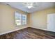 Comfortable bedroom with modern flooring, ceiling fan, and bright natural light at 6172 Catalina Dr. # 214, North Myrtle Beach, SC 29582