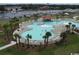 Aerial shot of a sprawling community pool with palm trees and plenty of lounge space at 6172 Catalina Dr. # 214, North Myrtle Beach, SC 29582