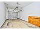 This garage features white walls, a garage door, and a concrete floor at 6172 Catalina Dr. # 214, North Myrtle Beach, SC 29582