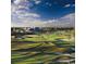 Scenic view of a lush golf course with rolling hills and clubhouse in the background at 6172 Catalina Dr. # 214, North Myrtle Beach, SC 29582