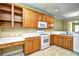 Well-lit kitchen featuring ample cabinet space, modern appliances, and a dedicated desk area at 6172 Catalina Dr. # 214, North Myrtle Beach, SC 29582