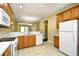 Bright eat-in kitchen features white appliances, tile flooring and a view of the dining area at 6172 Catalina Dr. # 214, North Myrtle Beach, SC 29582